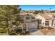 Landscaped two-story home with a manicured front lawn, desert landscaping and mountain views at 3425 Creek River Dr, Las Vegas, NV 89129