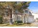 Charming two-story home with manicured lawn and mature shade tree in front at 3425 Creek River Dr, Las Vegas, NV 89129
