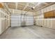 Clean, organized garage featuring finished walls, a large door, and ample storage for vehicles and equipment at 3425 Creek River Dr, Las Vegas, NV 89129
