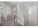 Upstairs hallway with neutral carpet leading to bedrooms and bathrooms at 3425 Creek River Dr, Las Vegas, NV 89129