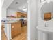 Eat-in kitchen with breakfast bar, stainless steel appliances, and wood cabinets at 3425 Creek River Dr, Las Vegas, NV 89129