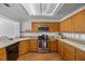 Bright kitchen with stainless steel appliances, oak cabinets, and a tile backsplash at 3425 Creek River Dr, Las Vegas, NV 89129
