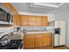 Bright kitchen featuring wooden cabinets, modern appliances, and a unique glass tile backsplash at 3425 Creek River Dr, Las Vegas, NV 89129