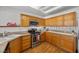Bright kitchen featuring wooden cabinets, modern appliances, and a unique glass tile backsplash at 3425 Creek River Dr, Las Vegas, NV 89129