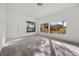 Bright living room with large windows, neutral carpet, and a welcoming atmosphere at 3425 Creek River Dr, Las Vegas, NV 89129