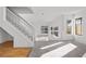 Spacious living room with a staircase, large windows, and carpet flooring throughout at 3425 Creek River Dr, Las Vegas, NV 89129