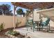 Outdoor patio area featuring a charming dining set and overhead pergola at 3425 Creek River Dr, Las Vegas, NV 89129