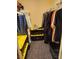 Organized walk-in closet with hanging clothes and storage bins at 3425 E Russell Rd # 161, Las Vegas, NV 89120