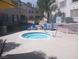 Community hot tub with lounge chairs, greenery, and blue skies, for relaxing with Gathering and friends at 3425 E Russell Rd # 161, Las Vegas, NV 89120