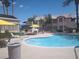 Community pool area and nearby seating area for Gathering and friends with blue skies and palm trees at 3425 E Russell Rd # 161, Las Vegas, NV 89120