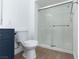Bathroom featuring a shower with glass doors, white toilet, and navy blue vanity at 3608 Pintadas St # 204, Las Vegas, NV 89108