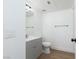Well-lit bathroom featuring a vanity with gray cabinets, a toilet, and a mirror at 3608 Pintadas St # 204, Las Vegas, NV 89108
