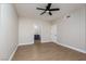 Neutral-toned bedroom featuring an ensuite bathroom, wood-look floors, and a ceiling fan at 3608 Pintadas St # 204, Las Vegas, NV 89108
