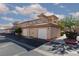 Beautiful townhome featuring a tan stucco exterior, Spanish tile roof, and attached two-car garage at 3608 Pintadas St # 204, Las Vegas, NV 89108