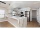 Stylish kitchen with white cabinets, stainless steel appliances, and quartz countertops at 3608 Pintadas St # 204, Las Vegas, NV 89108
