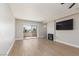Bright living room featuring a sliding glass door, fireplace, and wood-look flooring at 3608 Pintadas St # 204, Las Vegas, NV 89108