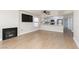 Open-concept living area with fireplace, window, and adjacent kitchen with modern stainless appliances at 3608 Pintadas St # 204, Las Vegas, NV 89108