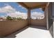 Private outdoor patio area with views of neighborhood rooftops and landscaping at 3608 Pintadas St # 204, Las Vegas, NV 89108