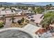 Aerial view of neighborhood with a single Gathering house, desert landscaping, and attached garage at 3619 Bixbee Ct, Las Vegas, NV 89129
