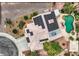 Aerial view of the home's roof featuring solar panels and a beautiful backyard pool and landscaping at 3619 Bixbee Ct, Las Vegas, NV 89129