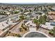Expansive aerial view of a suburban home featuring desert landscaping, a tile roof, solar panels, and neighboring properties at 3619 Bixbee Ct, Las Vegas, NV 89129
