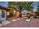 Charming backyard with mature trees, rock landscaping, and walkway at 3619 Bixbee Ct, Las Vegas, NV 89129
