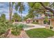 Inviting outdoor oasis with pool, spa, mature landscaping, and shaded patio at 3619 Bixbee Ct, Las Vegas, NV 89129