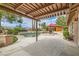 A covered patio overlooks an in-ground pool and outdoor kitchen, perfect for entertaining in your private outdoor space at 3619 Bixbee Ct, Las Vegas, NV 89129