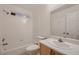 Bright bathroom featuring a bathtub with shower and a vanity with a large mirror at 3619 Bixbee Ct, Las Vegas, NV 89129