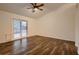 Bright bedroom with hardwood floors and a sliding glass door to the backyard at 3619 Bixbee Ct, Las Vegas, NV 89129