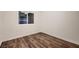Bedroom features hardwood floors and natural light from the window at 3619 Bixbee Ct, Las Vegas, NV 89129