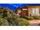 Inviting home entrance with lush landscaping, providing privacy and curb appeal at 3619 Bixbee Ct, Las Vegas, NV 89129