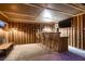 Finished wooden bar inside cabana with barstools, lighting and flat screen TV at 3619 Bixbee Ct, Las Vegas, NV 89129