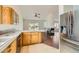 Open kitchen design with stainless steel refrigerator and view into the fireplace Gathering room at 3619 Bixbee Ct, Las Vegas, NV 89129