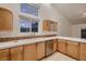 Bright kitchen with stainless steel appliances, tile backsplash and tiled countertops at 3619 Bixbee Ct, Las Vegas, NV 89129