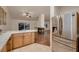 Kitchen with stainless steel refrigerator and view of the living room fireplace at 3619 Bixbee Ct, Las Vegas, NV 89129