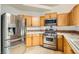 Well-lit kitchen featuring stainless steel appliances and tile countertops with ample cabinet space at 3619 Bixbee Ct, Las Vegas, NV 89129