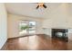 Bright living room with wood floors, fireplace, and sliding door leading to a pool and patio at 3619 Bixbee Ct, Las Vegas, NV 89129