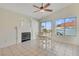 Cozy dining area with a fireplace, ceiling fan and natural light from the backyard sliding door at 3808 Lilac Haze St, Las Vegas, NV 89147