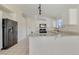 Spacious kitchen with a functional island, black appliances, and ample counter space for meal prep at 3808 Lilac Haze St, Las Vegas, NV 89147