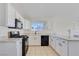 Bright kitchen features white cabinetry, granite countertops, and stainless steel appliances at 3808 Lilac Haze St, Las Vegas, NV 89147