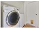 Convenient laundry area with a modern front-load washing machine and open shelving at 3808 Lilac Haze St, Las Vegas, NV 89147