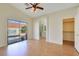 Spacious main bedroom with wood floors, ceiling fan, closet, and bathroom access at 3808 Lilac Haze St, Las Vegas, NV 89147