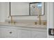 Bright bathroom featuring double vanity with gold fixtures and modern white cabinets at 3916 Green Leaf Dr, Las Vegas, NV 89120