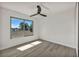 Bright bedroom with hardwood floors, ceiling fan, and large window at 3916 Green Leaf Dr, Las Vegas, NV 89120