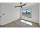 Bright bedroom featuring wood-look floors, ceiling fan, and large window with scenic views at 3916 Green Leaf Dr, Las Vegas, NV 89120