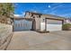 Gated driveway with a two-car garage and mature landscaping, providing privacy and curb appeal at 3916 Green Leaf Dr, Las Vegas, NV 89120