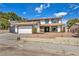 Two-story home featuring a two-car garage, beautifully landscaped front yard, and classic architectural details at 3916 Green Leaf Dr, Las Vegas, NV 89120