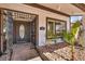 Charming home entrance with a decorative security door, tiled walkway, and desert-friendly landscaping at 3916 Green Leaf Dr, Las Vegas, NV 89120