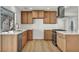 Updated kitchen featuring wooden cabinets, stainless steel appliances, and quartz countertops at 3916 Green Leaf Dr, Las Vegas, NV 89120